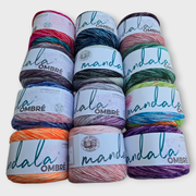 Stack of Mandala Ombre yarn with colorful skeins on a white background