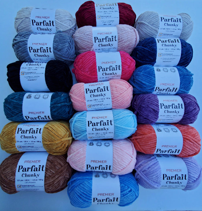Assorted colors of Premier Parfait Chunky yarn on a blue background